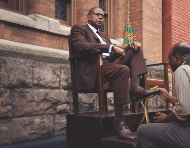 Man getting his shoe polished from Godfather of Harlem on EPIX